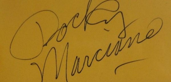 This AWESOME and seldom-seen piece of collector lore is a cut of bright yellow paper, measuring approximately 2.25x4.75, and in EX/MT shape.  It is hand-signed in what appears to be black ink by the only undefeated Heavyweight Champion in history, Rocky Marciano, and grades about a 7 overall.  With his tragic and untimely death now over a half century ago, this piece is valued into the low thousands, and perfect to use for a framed display with the photo of your choice--perhaps the famed Walcott photo?