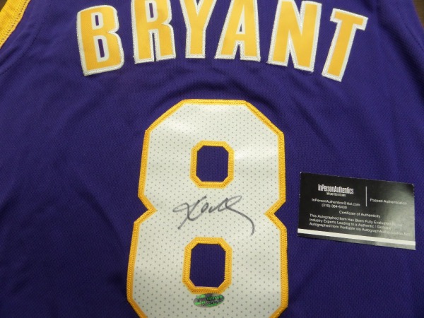 This VERY well designed and tailored road purple Lakers jersey has sewn on everything as well as name on back, and  comes back #8 signed in bold black sharpie. It, shows off well from 20 feet away, and even has the certainty intact via the InPerson Authentics lifetime COA and added hologram. Wow! 