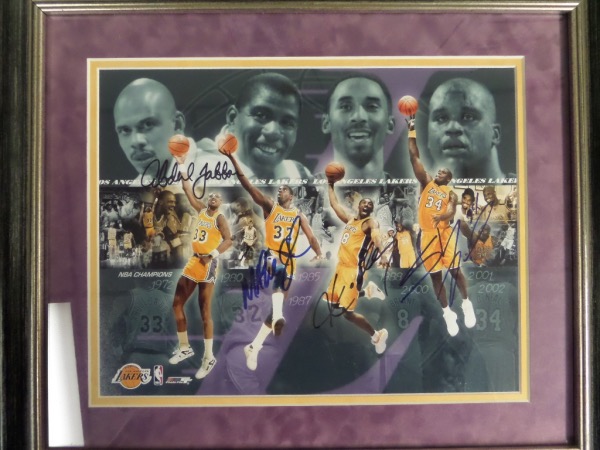 This super piece is custom double matted in Lakers team color gold and purple suede, and measures near 16x20 in size after pro framing in wood. It holds a color print which shows Kobe, Magic, Shaq and Kareem in action, comes boldly black sharpie signed by all, and shows off well from 20 feet away. It is a classy 10 all over, and value is well over a grand with the deceased Kobe, and always tough Kareem. 