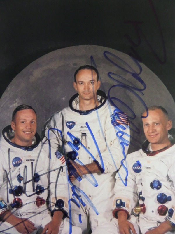 This full color 8.5x11 photograph shows the crew of famed 1969 mission, Apollo 11.  It is hand-signed in blue/black sharpie by all three, including Neil Armstrong (dec), Michael Collins, and Buzz Aldrin.  A perfect 8x10 size for framing and display, and with all three signatures present, valued well into the hundreds!