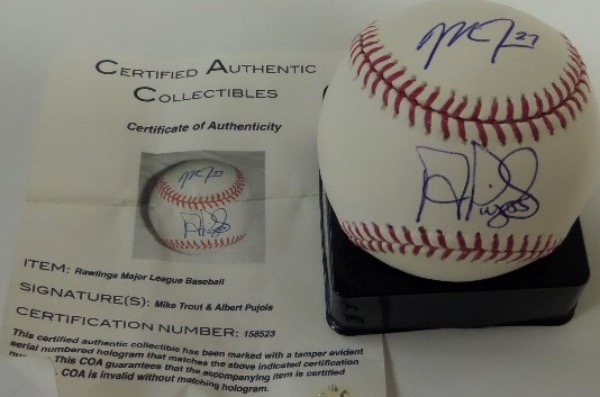 This Official Major League Baseball from Rawlings is in NM overall condition, and comes blue ink-signed by a pair of teammates destined for Cooperstown.  Included are Mike Trout on the top panel and Albert Pujols across the sweet spot, with signatures grading clean 9's or better, and the ball includes a photo COA from Certified Authentic Collectibles.  Valued into the high hundreds!