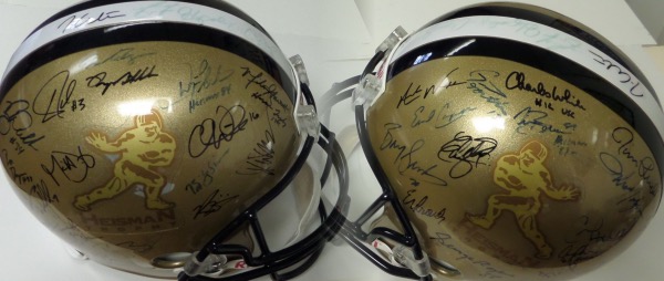 This stunning display item is a black Heisman Trophy logo full size replica helmet from Riddell in NM/MT condition, and hand signed in blue/black sharpie by more than 40 winners of the coveted NCAA football award.  Included are marquee names like Barry Sanders, Jim Plunkett, Charles White, Ty Detmer, George Rogers, Tim Brown, Hopalong Cassady, Mike Garrett, Chris Weinke, Marcus Allen, Roger Staubach, Danny Wuerffel, Paul Hornung, Ron Dayne, Tony Dorsett, Bo Jackson, Reggie Bush, Doug Flutie, O.J. Simpson and many more.  A MUST for the Heisman collector or college football fan, and valued well into the thousands!