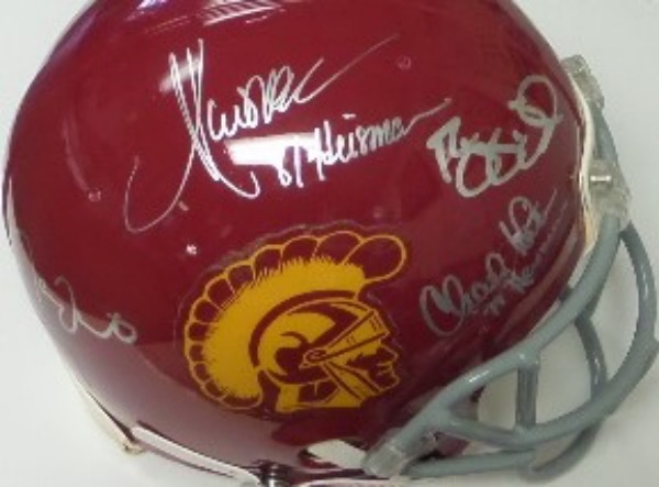 This like new Pro-Line helmet cost $300.00 BEFORE our 4 Heisman winners even signed it, and is valued upwards of a grand now. I see signatures from Marcus Allen, Matt Leinert, Reggie Bush and Charles White, and all appear stunning in silver paint pen. terrific NCAA piece, and sold here with NO reserve. 