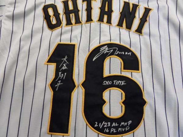 This white size L custom #16 Japan Ohtani jersey is in NEW condition, with everything hand-sewn.  It is back number-signed in bright silver by the 2021 AL MVP himself, written in both English and Japanese, grading an 8 at least, w/ SHO TIME and 21/23 AL MVP 16 PL MVP inscriptions.  A great looking jersey, and retail is high hundreds right now at least!