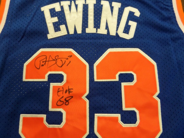 This blue 1991-92 Knicks throwback jersey from Mitchell & Ness still has original tagging attached, and is trimmed in white and orange, with everything professionally-stitched.  It is back number-signed in black sharpie by the HOF center himself, grading a legible 8-8.5 and including a HOF 08 inscription, and will frame and display beautifully for your Knicks collection.  Valued into the mid hundreds!