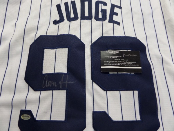 This mint home white pinstripe is, trimmed in team blue colors, and complete with sewn on everything as well as name on back. It comes back #99 signed by the future HOF'er in perfect silver paint pen, shows off well from 12 feet away, and even has certainty added via InPerson Authentics lifetime COA and added hologram. 