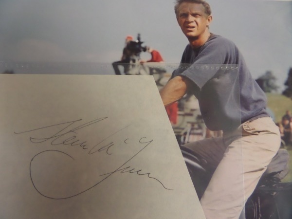 This vintage cut of white paper is sizable and irregularly-shaped, in EX/MT condition, and bears the black ink signature of Hollywood action icon, Steve McQueen.  The autograph grades about a 5, and the cut comes with a color "Great Escape" photo of McQueen for matting and framing for display.  Valued well into the hundreds!