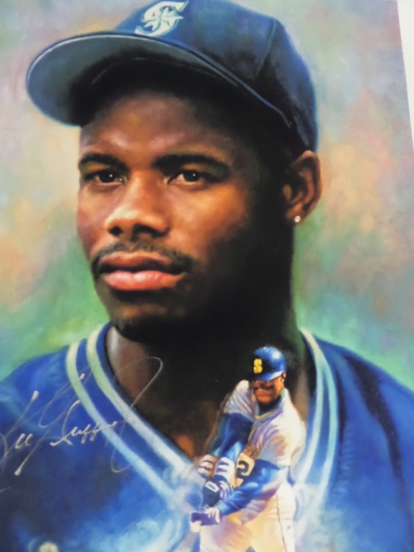 This stunner is about 20x24 in size, almost on a silk like canvas, and shows the MLB HOF star  in blue and green team colors. It is a beauty, obviously by a talented artist, and comes hand signed in silver paint pen. High value, an sold here with NO reserve. It is a must frame NBA investment, and looks amazing from across our room. 
