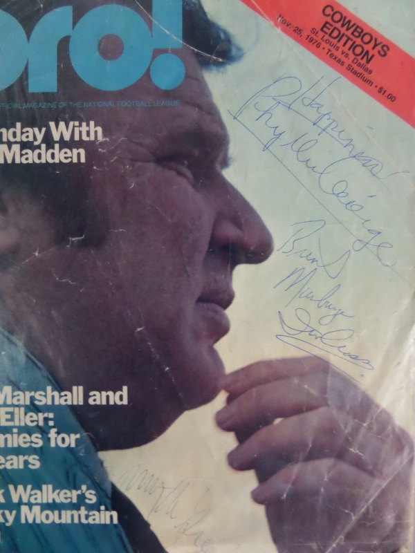 This 1976 dated original is a color cover only from a PRO magazine, shows John Madden from the Raiders,and comes ink signed by all FOUR broadcasters, 3 of which are now deceased. It is in VG condition with creasing evident, and Irv Cross, Phyllis George, Brent Musberger and Jimmy "The Greek" Snyder have all signed. IN PERSON obtained, guaranteed to pass JSA or PSA, and a very RARE one of a kind!!