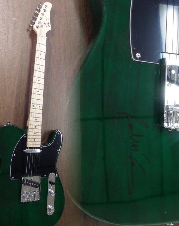 This gorgeous dark green mint electric Glarry guitar comes with the original box, pick ups, bag, straps,etc. and comes signed by the best singer/songwriter of all time in black. SUPERB autograph and shows off wonderfully. Guaranteed authentic and get it now because Paul is a tough autograph and not getting any younger! 