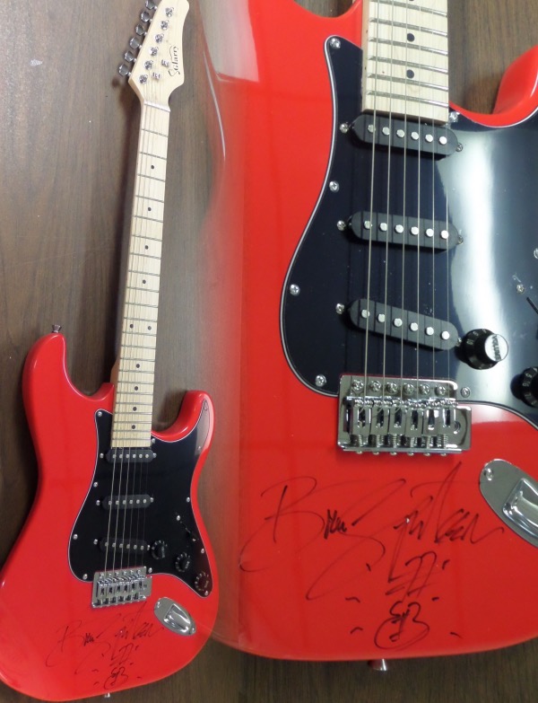 This mint bright red electric beauty comes in the original box with accessories/carry bag included. It comes signed PERFECTLY by this legend in black sharpie with a hand drawn picture of a guitar added by the Boss!!!  Guaranteed authentic and as nice as you will ever see from Bruce! Retails into the thousands.
