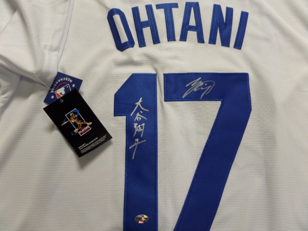 This home white size L Los Angeles Dodgers jersey from Nike is in store-bought condition, comes trimmed in hand-sewn royal blue, and is back number-signed in silver by the Dodgers brand new pitcher/hitter, Shohei Ohtani!  The signature grades a legible 9, is in both English and Japanese, and though the guy cost LA $700 million, his jersey can probably be had for less!