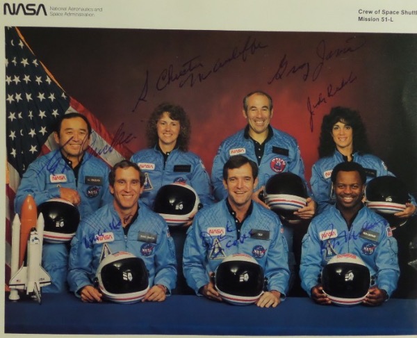 This amazing collector's item is a full 8x10 color NASA photo of all seven members of the "Challenger" mission, all of whom died tragically in the take off explosion.  It is hand-signed in blue ink by all seven, including McAuliffe, Jarvis, McNain, Onizuka, Resnik, Smith and Scabee and this piece values well into the thousands!