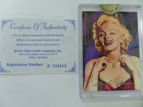 This MINT Slabbed Marilyn Monroe REAL DIAMOND card #1D comes sealed and with certificate from Sportstime wityh registration number. THe card is MINT in hard plastic case and shows Marilyn wearing her DIAMOND necklace with facsimile signature on card. THese cards are EXTREMELY RARE and well valued near $2500.