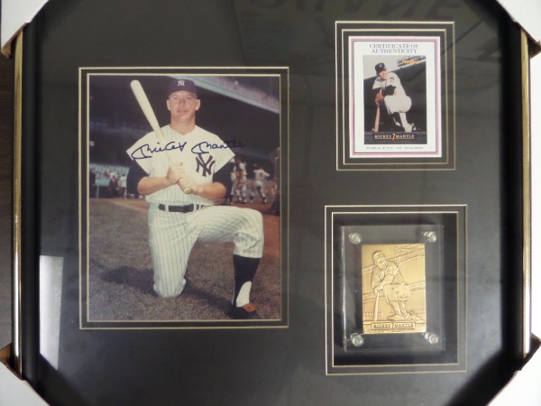 This nearly square 19x20 professionally-framed and custom double-matted display houses a COA from Pinnacle, a gold card, and a color 8x10 that is hand-signed in dark blue sharpie by The Mick himself.  The signature grades an overall 9, and this display-ready piece is valued into the very high hundreds!