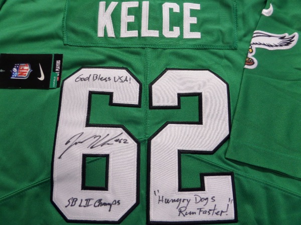 This Kelly green size L Eagles jersey from Nike is still tagged as new, and has everything professionally-sewn.  It is back number-signed in black sharpie by one of the most popular players in franchise history, and yes, he's a CENTER!  Of course, we're talking about future HOF'er Jason Kelce, and he has signed this one beautifully in black sharpie, grading a 9, with #62, "Hungry Dogs Run Faster," God Bless USA! and SB LII Champs! inscriptions!  Valued into the mid/high hundreds!!!