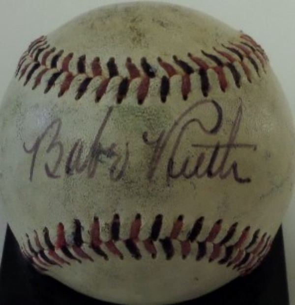 This very old baseball is stitched in black and red, with WORLD SERIES in caps on the reverse sweet spot.  It is hand-signed across the sweet spot in black fountain pen ink by the Yankees all time great and HOF legend himself, the signature grading a large and still legible 7+.  A fine example of a Ruth autograph, and retail is well over 30k all day long!