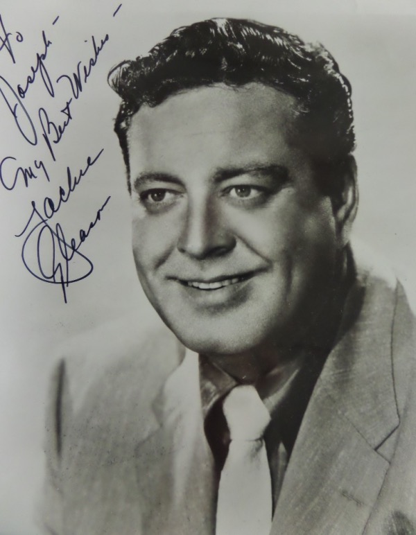 This black and white 8x10 photo is an image of a younger Jackie Gleason posing for the camera, probably in the 1950's.  It is hand-signed by the comedic legend himself, grading a strong 9, personalized To Joseph, with a My Best Wishes inscription, and with Gleason now long gone, retail is mid/high hundreds!