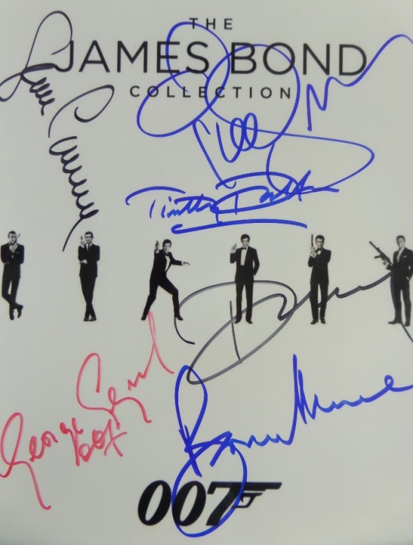 This "James Bond Collection 007" logo B&W photo print comes autographed in red, blue and black sharpie by all six actors who have portrayed the super spy in film.  Included are Sean Connery, George Lazenby, Roger Moore, Timothy Dalton, Pierce Brosnan and Daniel Craig.  A great looking piece, with beautiful signatures, each grading 9 or better, and valued into the mid hundreds!