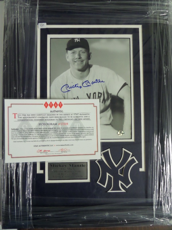 This 16x122 professionally-framed and white/navy double-matted display features a custom silver metal nameplate, a special NY logo, and a black and white photo of the great Mickey Mantle.  The photo is hand-signed in blue sharpie by The Mick himself, grading a strong 8.5 at least, and this display-ready piece is fully STAT certified for authenticity purposes.  Retail = $999.99!!!