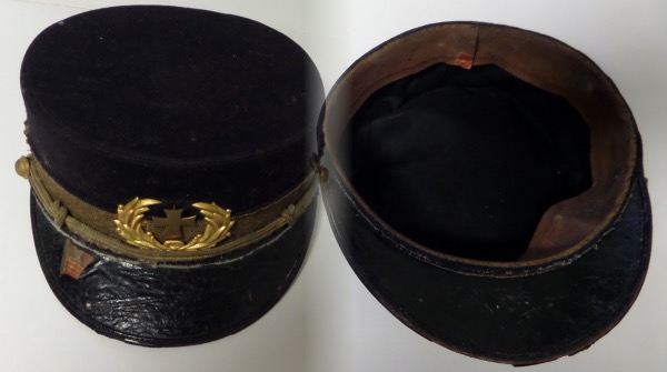 This museum worthy relic is a real civil war hat, worn by a clergy, and comes to you complete with emblems. It is a Union Blue, shows obvious wear but no abuse, and should sell for many times our opening bid pricing.  
