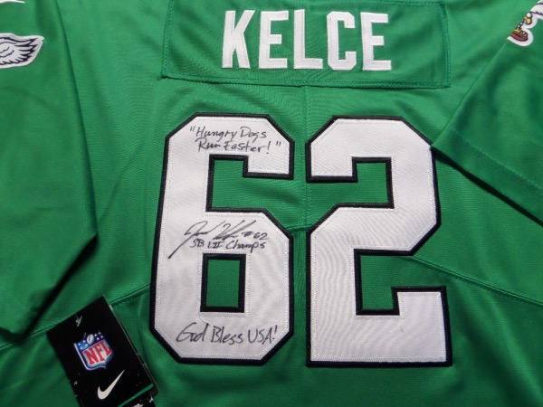 This Kelly green size L Eagles jersey from Nike is still tagged as new, and has everything professionally-sewn.  It is back number-signed in black sharpie by one of the most popular players in franchise history, and yes, he's a CENTER!  Of course, we're talking about future HOF'er Jason Kelce, and he has signed this one beautifully in black sharpie, grading a 9, with #62, "Hungry Dogs Run Faster," God Bless USA! and SB LII Champs! inscriptions!  Also included is an autographed Panini football card, just to whet your appetite a bit more! Valued into the mid/high hundreds!!!