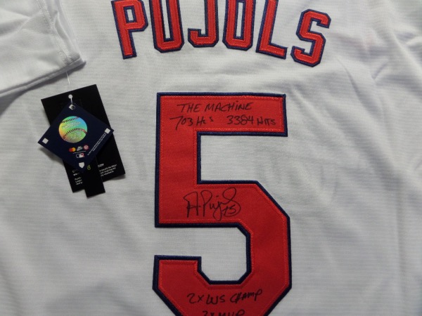 This home white size L St. Louis Cardinals Pujols #5 jersey is from Nike, and comes to us still with original tagging.  It has everything professionally-stitched, and comes back number-signed in black sharpie by the all time great and future HOF'er himself.  The signature grades an overall 8-8.5, and includes 703 Hr's 3384 Hits, 2X WS CHAMP, 3X MVP and THE MACHINE inscriptions.  With his 700th home run, recent retirement, and inevitable HOF induction in four years, this jersey is absolutely scorching right now on the retail circuit!