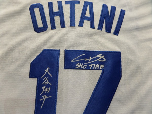 This white size L custom #17 Dodgers Ohtani jersey is in NEW condition, with everything hand-sewn.  It is back number-signed in bright silver by the 2021 AL MVP himself, written in both English and Japanese, grading an 8 at least, w/ a cool SHO TIME inscription.  A great looking jersey, and retail is high hundreds right now at least!