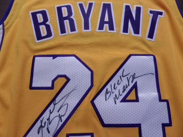 This yellow size 50 Kobe Bryant #24 Lakers 06-07 throwback jersey is like new, and comes trimmed in purple and white, with everything sewn.  It is hand-signed in his full name on the back number in black sharpie by the all time great himself, with a cool Black Mamba inscription added, and with his 2020 death, this amazing looking jersey is valued well into the low thousands!