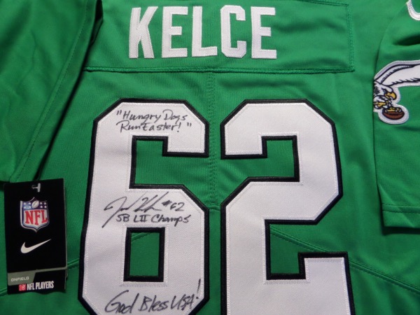 This Kelly green size L Eagles jersey from Nike is still tagged as new, and has everything professionally-sewn.  It is back number-signed in black sharpie by one of the most popular players in franchise history, and yes, he's a CENTER!  Of course, we're talking about future HOF'er Jason Kelce, and he has signed this one beautifully in black sharpie, grading a 9++, with #62, "Hungry Dogs Run Faster," God Bless USA! and SB LII Champs inscriptions!  Valued into the mid/high hundreds!!!