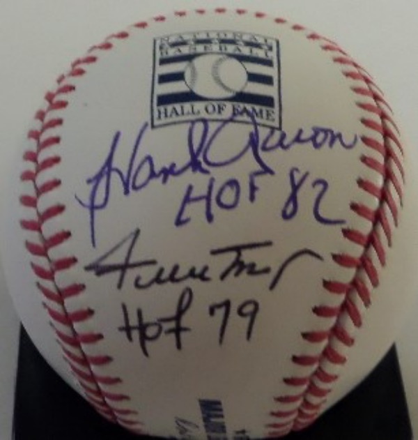 This National Baseball Hall of Fame logo Official Major League Baseball from Rawlings is cubed in NM/MT condition, and comes hand signed on the logo panel by all time greats Hank Aaron and Willie Mays.  Aaron's blue ink signature includes a HOF 82 inscription, and Mays has included HOF 79.  A fantastic and unique collector's item, and with Aaron gone and Mays in this early '90's, retail is high hundreds!!!