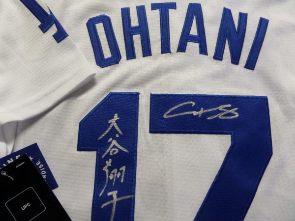 This white size L custom #17 Dodgers Ohtani jersey is still tagged as new, and comes trimmed in royal blue, with everything hand-sewn.  It is back number-signed in bright silver by the 2 time AL MVP himself, written in both English and Japanese, grading an 8 at least.  A great looking jersey, and retail is high hundreds right now at least!