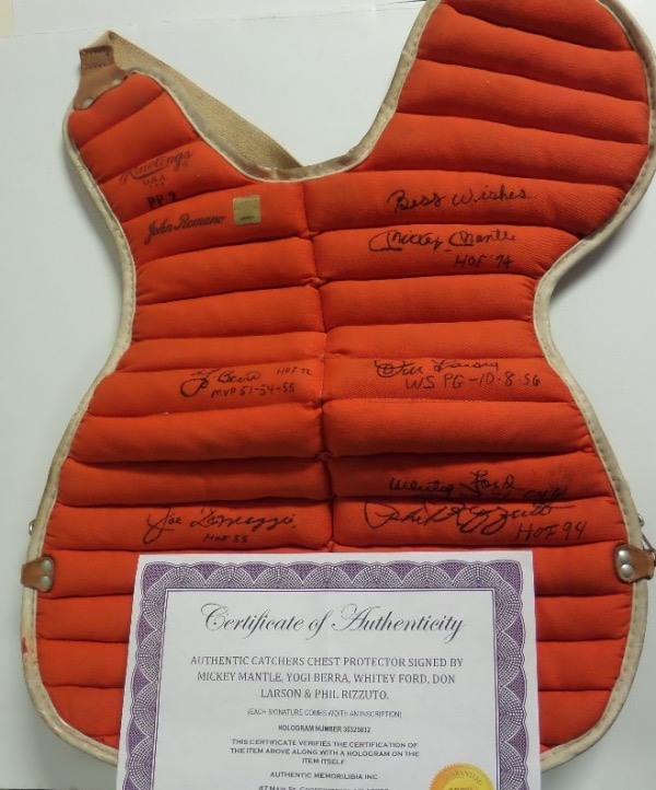 This super cool piece is a vintage 1960's real catchers chest protector, orange in color, and comes black sharpie signed by many all-time NYY Greats. I see scribs from Mantle, Ford, berra, Larsen, DiMaggio and Rizzuto, and value with the Cooperstown LOA from Authentic Memorabilia is about a grand. 