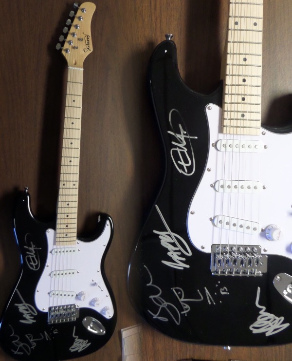 This black "strat style" electric guitar comes silver paint pen signed by all four band members, including Bono--with an added self sketch--Edge, Larry and Adam!!  An amazing, "Hard Rock Cafe" style display item that will shine in any rock music collection, and retail potential here is into the low thousands!