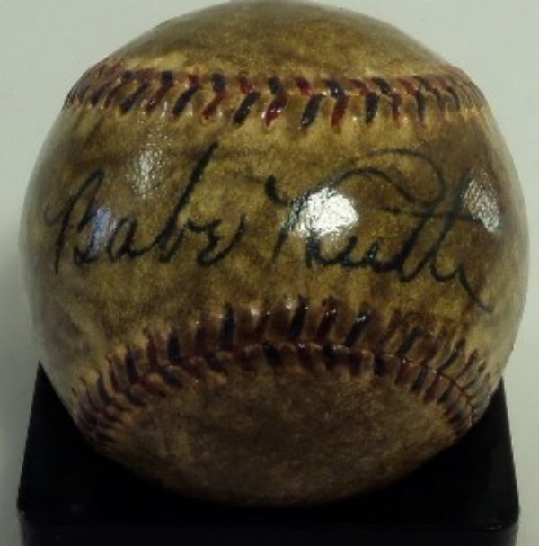 This very old baseball is stitched in black and red, with WORLD SERIES in caps on the reverse sweet spot.  It is hand-signed across the sweet spot in black fountain pen ink by the Yankees all time great and HOF legend himself, the signature grading a large and still legible 7+.  A fine example of a Ruth autograph, and retail is well over 30k all day long!