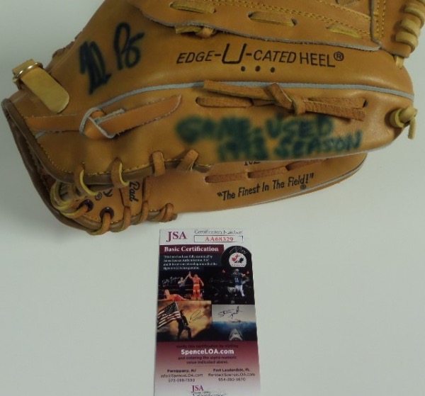 This Nolan Ryan signature model mitt from Rawlings is still in NM condition, and that's saying something, because it was actually used during the '93 season by Ryan himself.  How do we know this?  Well, he wrote it on the glove, and signed it as well, both in blue sharpie, and though the signature and inscription bleed a bit, they still grade 7's.  The glove includes a COA from JSA for authenticity (AA68329), and retail is low thousands, with a bargain basement minimum bid evident!!!