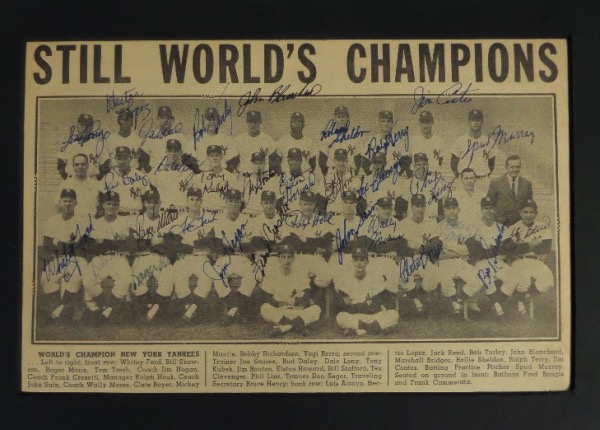 This 9x14 black-matted display is in EX/EX+ overall condition, and houses a black and white newspaper/magazine team photo of the '62 Yanks, with a STILL WORLD CHAMPS headline.  It is hand-signed in blue and black ink by more than 30 members of the squad, including MANTLE,Yogi Berra, Ralph Houk, Roger Maris, Whitey Ford, Bob Turley, Tony Kubek, Elston Howard, Bobby Richardon, Johnny Sain, Frank Crosetti, Tom Tresh, Ralph Terry and more.  AWESOME Bronx Bombers item, and with many now deceased, retail is low thousands!