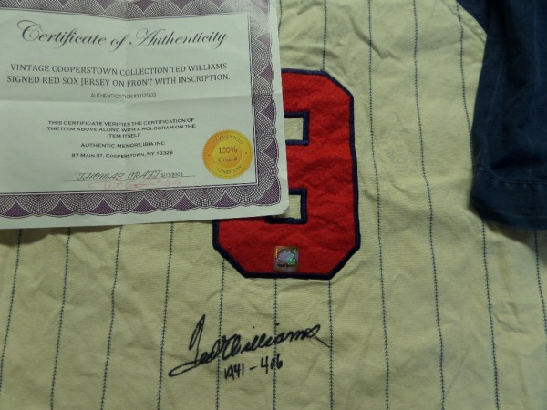 This 1989 era Cooperstown Collection jersey has sewn on everything, comes black sharpie signed by the late, great 500 HR Hitter, and has "1941 .406" written as a bonus by Teddy. It is a gem, shows off EZ from 30 feet away, and has both a COA and lifetime hologram affixed from Authentic Memorabilia in Cooperstown for assurance. 