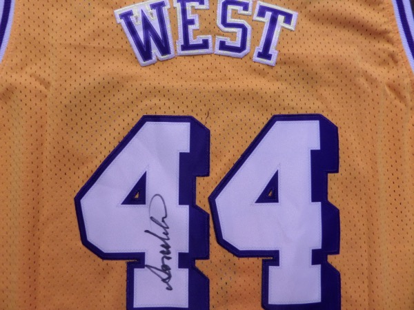 This yellow XXL custom Los Angeles Lakers basketball jersey from Adidas is still tagged as NEW, and comes trimmed in white and purple, with everything carefully hand-stitched.  It has been back number-signed in black sharpie by perhaps the greatest point guard that ever lived, the incomparable Jerry West, and the signature grades an overall 8-8.5.  With West's recent passing, retail on a crown jewel jersey like this is low thousands, to be certain!!!