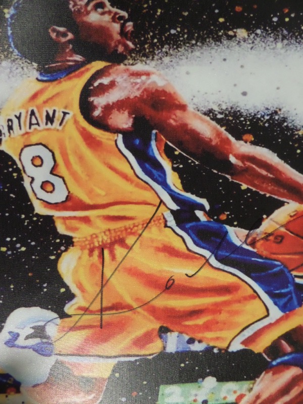 This full color artist's litho print is done on an actual canvas, measuring 18x22, and in NM/MT condition.  It is an image of Kobe Bryant in the midst of a reverse two-handed jam, and comes hand-signed in black sharpie by the all time NBA great himself.  With his death now just short of 5 years ago, retail is low thousands!