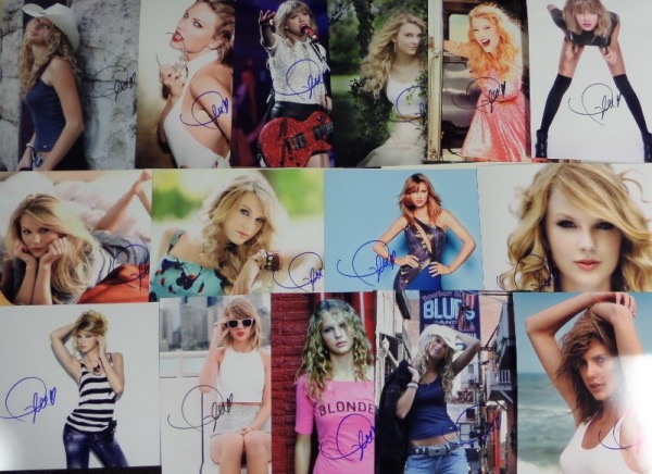 This ideal group lot is FIFTEEN full color 8x10 photos, including different shots, each hand-signed by the superstar pop/country singer.  Each photo can retail into the hundreds with the huge popularity of Swift, so you do the math with FIFTEEN!!!