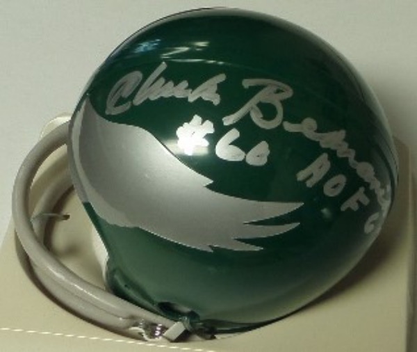 This green throwback Philadelphia Eagles mini football helmet from Riddell is boxed in MINT condition, and comes hand-signed by their most legendary player EVER, HOF linebacker/center, Chuck Bednarik.  The signature grades a strong 9, including #60 and HOF 67 inscriptions, and retail from this deceased all time great is well into the hundreds!