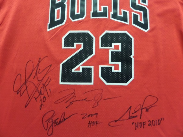 This red size 50 Jordan #23 Bulls jersey from Nike is tagged as NEW, and omes trimmed in black and white, with everything sewn.  It is front-signed by a trio of HOF greats, including Michael Jordan, Dennis Rodman, and Scottie Pippen, as well as HOF coach, Phil Jackson, each grading a clean 8 or better.  A MUST for Bulls fan, but really, a truly fantastic NBA item, and one valued into the thousands!