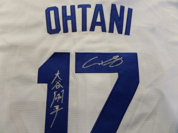 This white size L custom #17 Dodgers Ohtani jersey is still tagged as new, and comes trimmed in royal blue, with everything hand-sewn.  It is back number-signed in bright silver by the 2 time AL MVP himself, written in both English and Japanese, grading an 8 at least.  A great looking jersey, and retail is high hundreds right now at least!