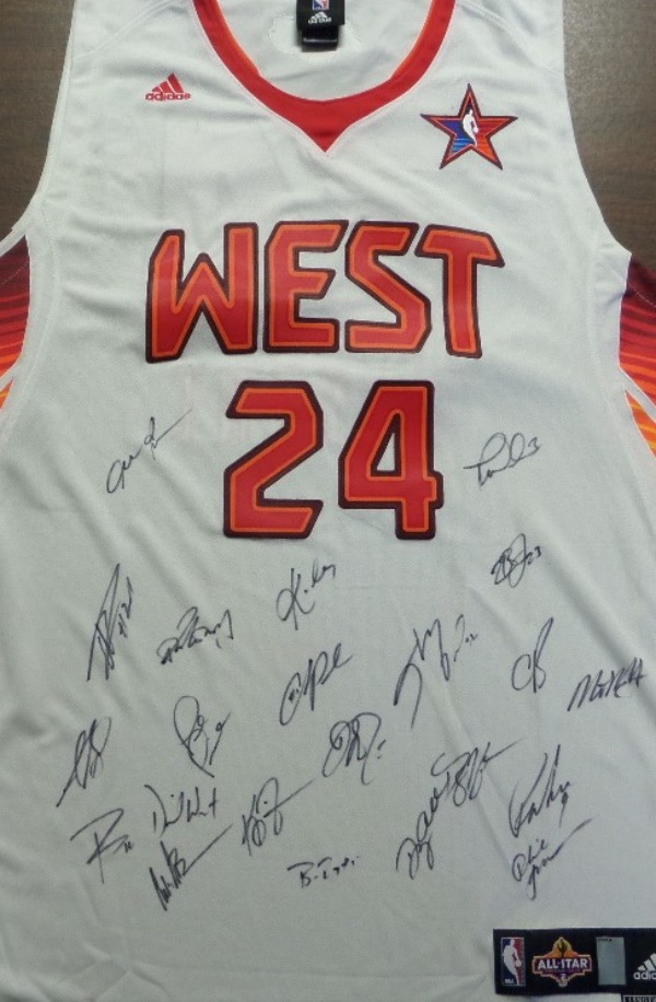 This colorfully done home white has "Bryant" sewn on back from the "West" All-Stars, and comes black marker signed by not only Kobe, the late, great HOF Legend, but by 15+ of his NBA fellow all-stars as well. Easy enough to make out IF you know NBA autographs, but all we know is that Kobe, Shaq, LeBron and Iverson signed it!! 