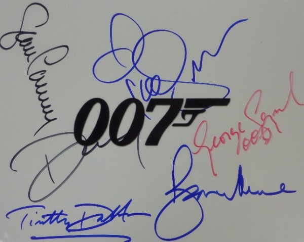 This "James Bond Collection 007" logo B&W photo print comes autographed in red, blue and black sharpie by all six actors who have portrayed the super spy in film.  Included are Sean Connery, George Lazenby, Roger Moore, Timothy Dalton, Pierce Brosnan and Daniel Craig.  A great looking piece, with beautiful signatures, each grading 9 or better, and valued well into the mid/high hundreds, especially with Moore and Connery no longer living!