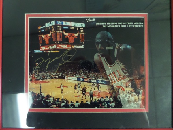 This rare item is a full color 8x10 print, shows the best ever inside the old Chicago Stadium in two different images, and comes gold paint pen signed by Mike on a great spot. It is a gem all over, and even comes pro double matted and framed in red and black team colors. High value, and of course, NO reserve here at the "Corner".  