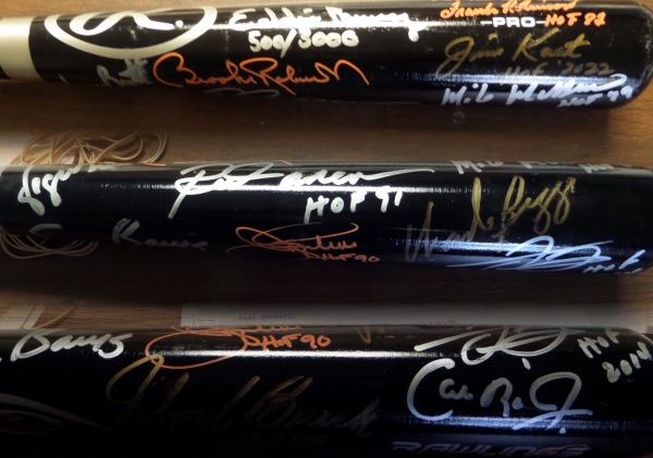 This black Pro bat from Rawlings is in NM condition, and comes hand-signed on the barrel in both silver sharpie and orange paint pen by 14 members of the Hall!  Included are Frank Robinson, Eddie Murray, Jim Kaat, Mike Mussina, Brooks Robinson, George Brett, Robin Yount, Rod Carew, Wade Boggs, Jim Palmer, Frank Thomas, Ernie Banks, Cal Ripken Jr., and Johnny Bench, and retail on this gorgeous bat is thousands!