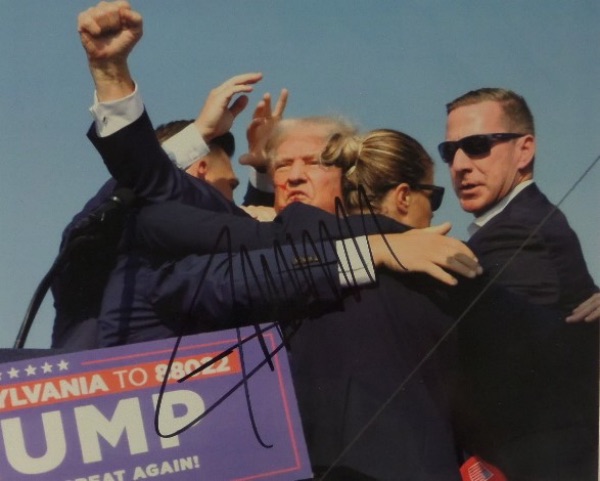 This full color 8x10 photo shows the US Presidential candidate encouraging his supporters to "fight" immediately following the assassination attempt in July.  It is black sharpie-signed by 45 (and possibly 47) himself, and will make for quite the conversation piece when framed for display.  Valued into the low thousands right now!