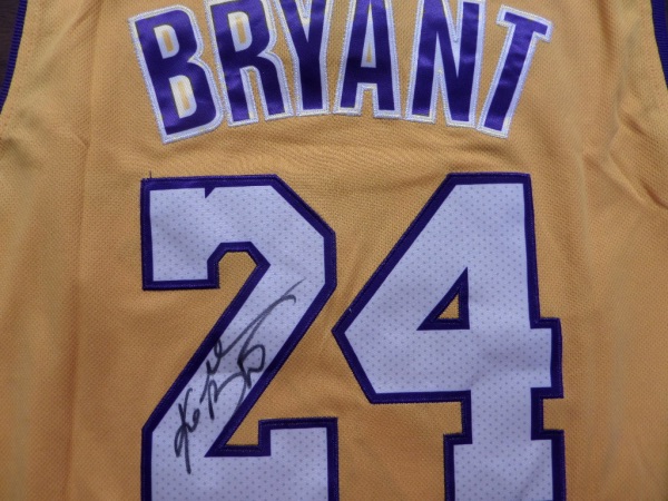 This yellow size L Kobe Bryant #24 Lakers jersey from Adidas is like new, and comes trimmed in purple and white, with everything sewn.  It is hand-signed in his full name on the back number in black sharpie by the all time great himself, and with his 2020 death, this amazing looking jersey is valued well into the low thousands!